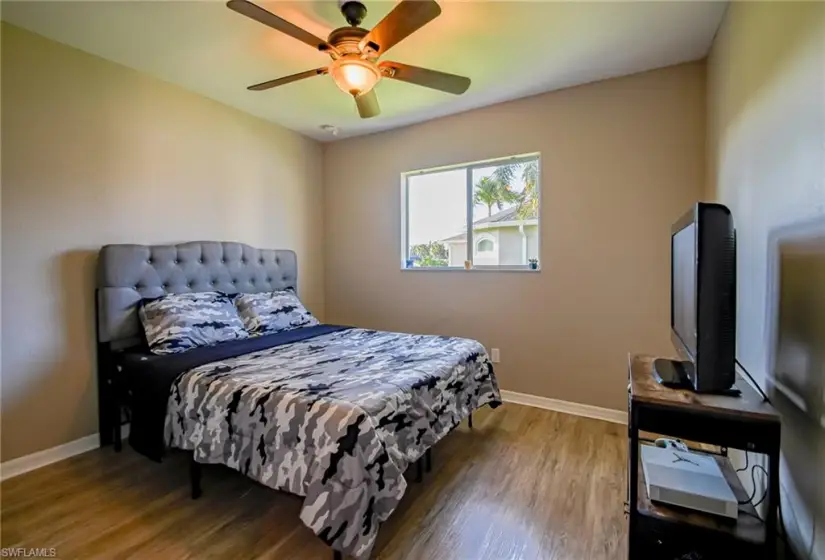 Bedroom with ceiling fan and wood-type flooring